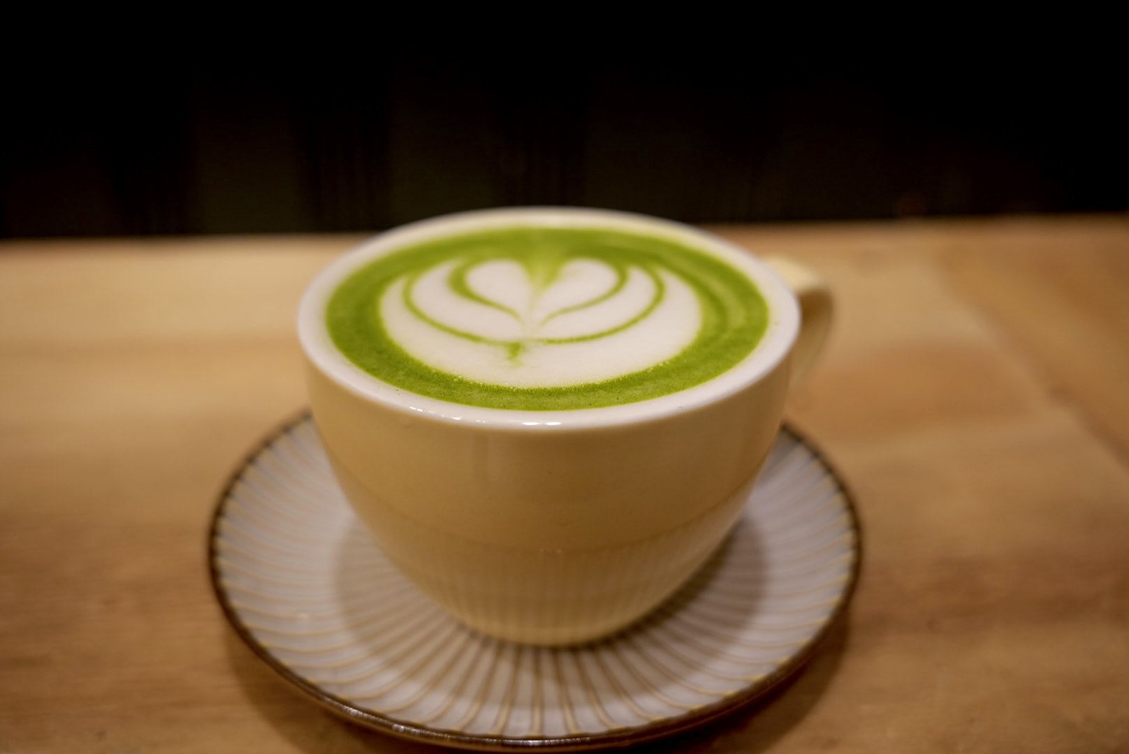 Green matcha latte with heart design