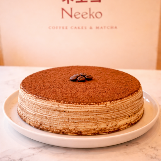 Tiramisu mille crêpes cake with coffee cream layers and cocoa dusting – Neeko